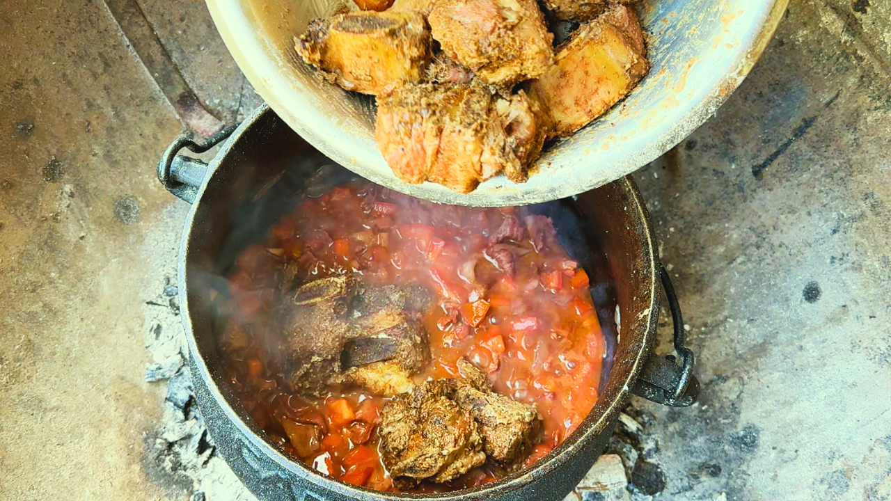 Oupa's beef short rib potjie in cast iron over fire with pap